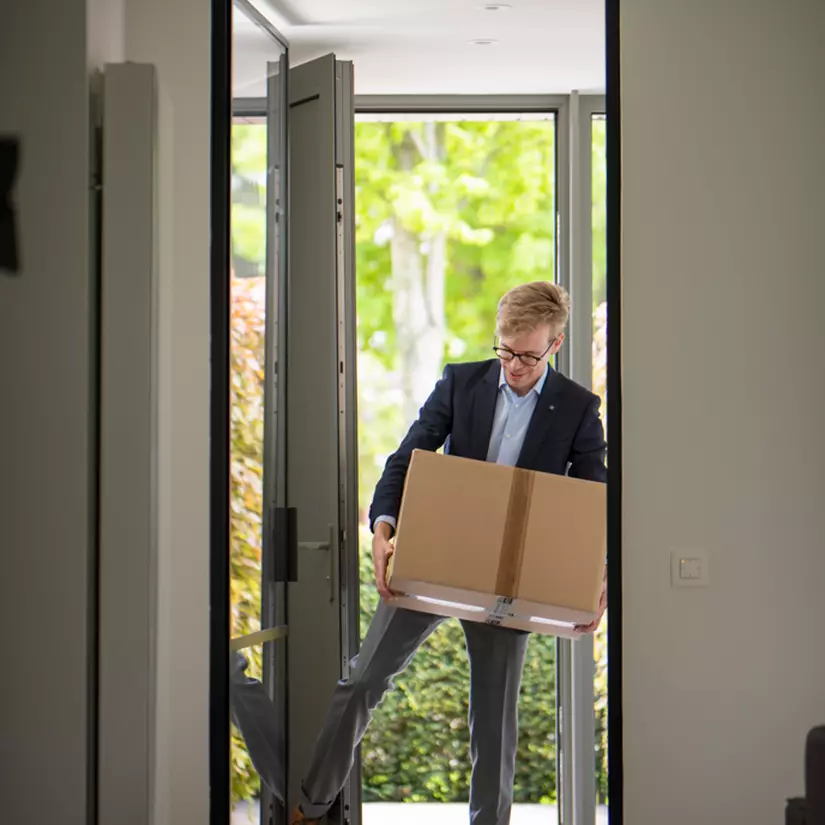 Person entering smart building with package